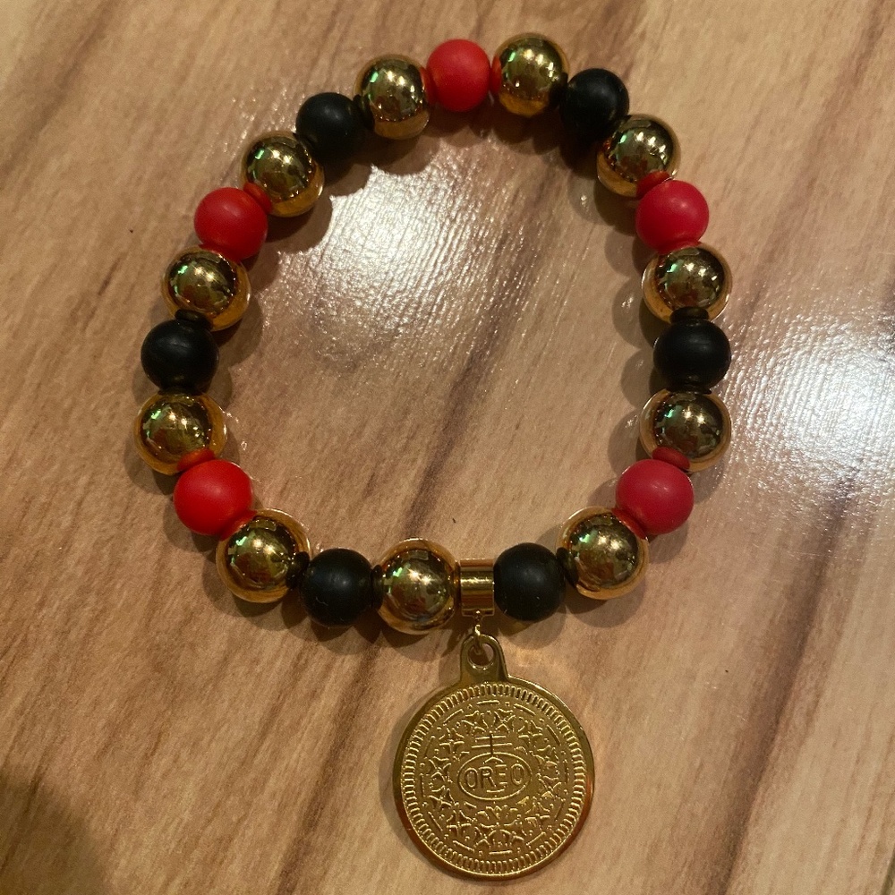 Red, Gold & Black stretch bracelet with Oreo Charm